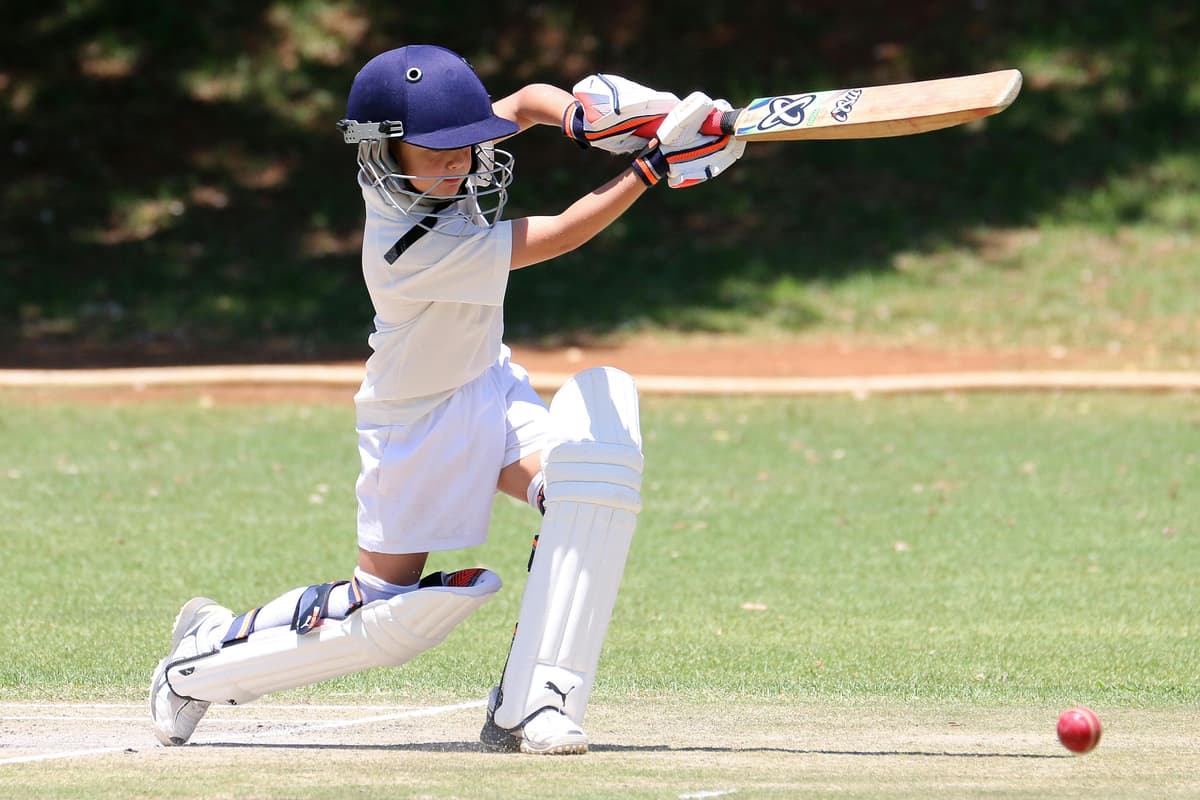 Young cricketer playing a batting shot